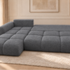 Grafitowa rozkładana sofa w jasnym salonie Narożnik z funkcją spania i pojemnikiem Milo lewy ciemnoszary boucle