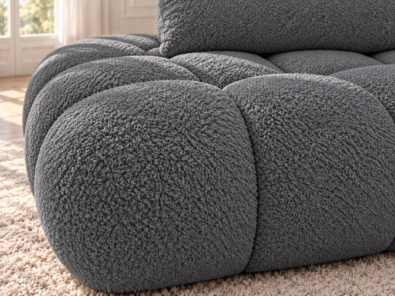 Grafitowa sofa boucle w naturalnym świetle Narożnik Soffy prawostronny z funkcją spania i pojemnikiem ciemnoszary boucle