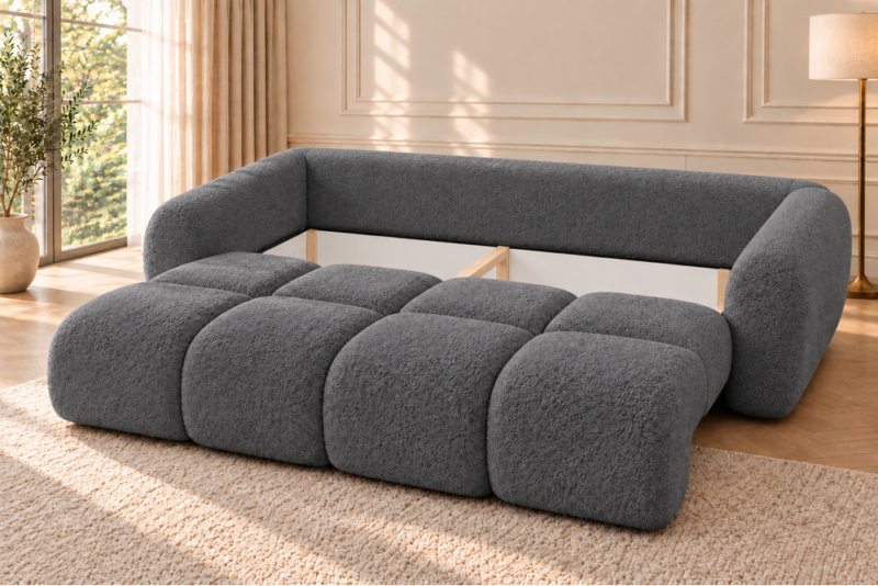 Grafitowa sofa modułowa w jasnym salonie Sofa z funkcją spania i pojemnikiem na pościel Milo ciemnoszara boucle