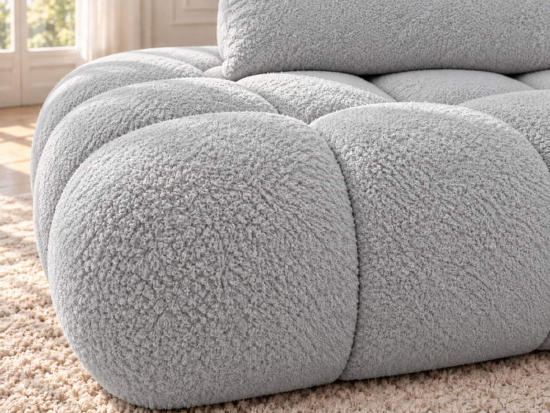 Jasnoszara sofa boucle w ciepłym świetle Narożnik Soffy prawostronny z funkcją spania i pojemnikiem szary boucle