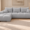 Jasnoszara sofa boucle w eleganckim salonie Narożnik z funkcją spania i pojemnikiem Aurio lewy szary boucle