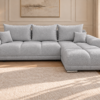 Jasnoszara sofa boucle w eleganckim salonie_PRAWY Narożnik z funkcją spania i pojemnikiem Aurio prawy szary boucle