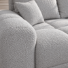 Jasnoszara sofa boucle w zbliżeniu_PRAWY Narożnik z funkcją spania i pojemnikiem Aurio prawy szary boucle