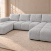 Jasnoszara sofa w ciepłym wnętrzu Narożnik z funkcją spania i pojemnikiem Milo U szary boucle