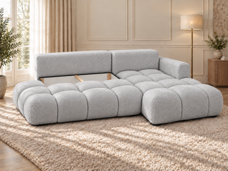 Jasnoszara sofa w eleganckim wnętrzu Narożnik Soffy prawostronny z funkcją spania i pojemnikiem szary boucle