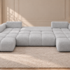 Jasnoszara sofa w pozycji do spania Narożnik z funkcją spania i pojemnikiem Milo U szary boucle