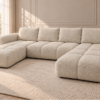 Kremowa sofa z delikatną fakturą boucle Narożnik z funkcją spania i pojemnikiem Milo U kremowy boucle