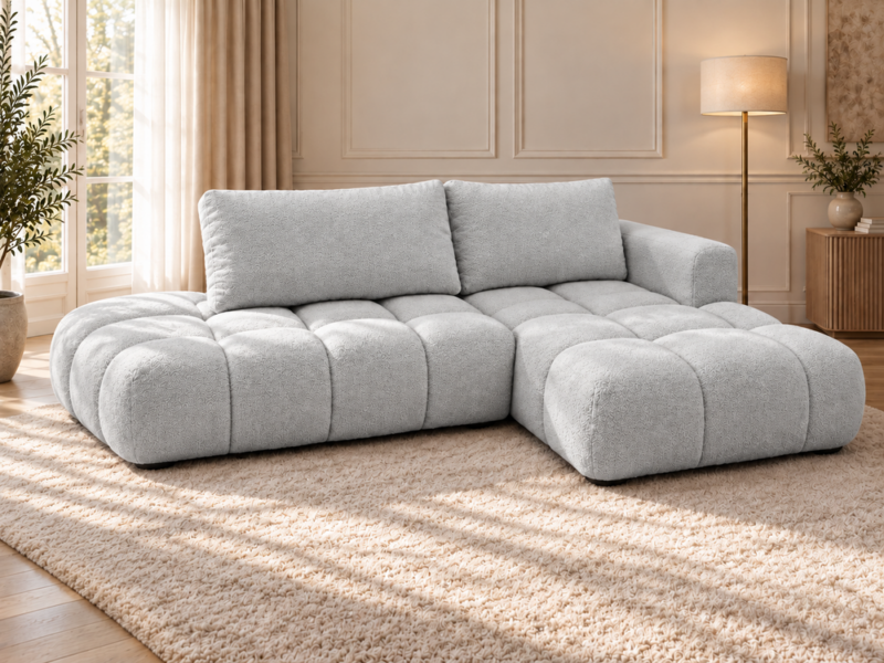 Szara pikowana sofa w słonecznym salonie Narożnik Soffy prawostronny z funkcją spania i pojemnikiem szary boucle