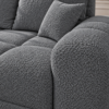 Szara sofa boucle w zbliżeniu Narożnik z funkcją spania i pojemnikiem Aurio lewy ciemnoszary boucle
