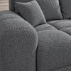 Szara sofa boucle w zbliżeniu_PRAWY Narożnik z funkcją spania i pojemnikiem Aurio prawy ciemnoszary boucle